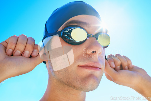 Image of Swimming cap, goggles and sports man ready for exercise, outdoor workout or training for summer contest. Swimwear, blue sky or face of swimmer start waterpolo competition, cardio or fitness challenge