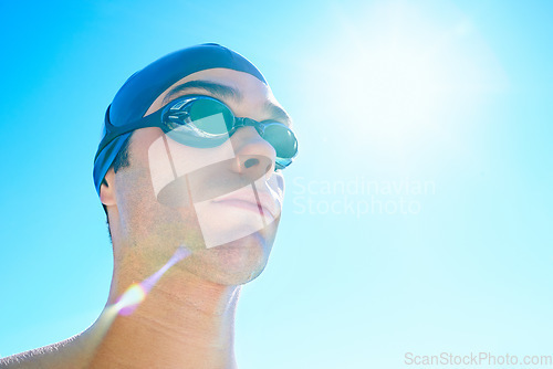 Image of Swimmer, sky and face of sports man determined for exercise, outdoor workout or training routine. Swimwear, sunshine or athlete with cap, goggles and commitment to summer challenge, fitness or cardio