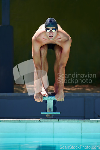 Image of Swimming, sports and man on start block, platform or podium for outdoor fitness exercise, practice or race. Training, athlete and swimmer ready for competition, cardio performance or contest