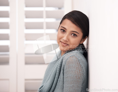 Image of Woman, portrait and smile in a new home on the floor and carpet relax in the morning. Lounge, happy face and female person from India with living room, real estate and calm in a house by a wall