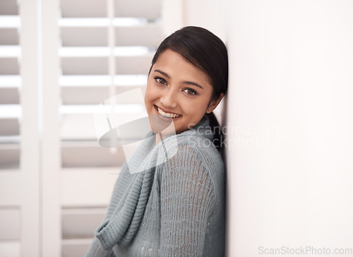 Image of Indian woman, portrait and smile in a new home relax in the morning. Lounge, happy and female person face with mockup space, real estate and calm in a house leaning on a room wall in a bedroom