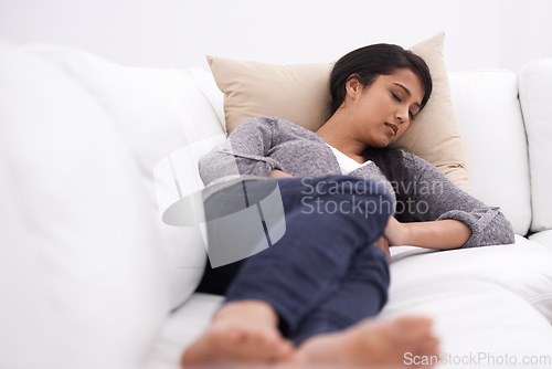 Image of Sleeping, woman and sofa in the morning with rest, fatigue and nap in a home. Tired female person, couch and relax in a lounge with dreaming, house and living room with peace, sleepy and calm