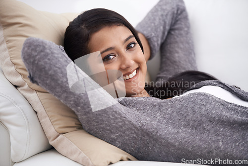 Image of Relax, woman and sofa with portrait, smile and happy from nap and rest in the morning at home. Living room, lounge and couch with a female person from India on a break with peace and calm in house