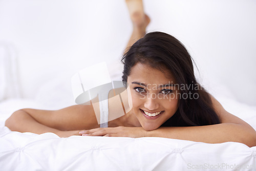 Image of Woman, bed and portrait in the morning happy from rest and sleep in a home with a smile. Indian female person, bedroom and wake up on duvet with peace and calm in a house on a blanket with comfort