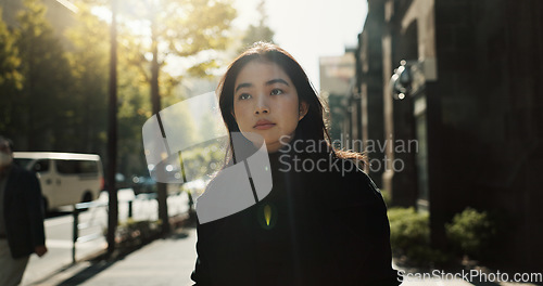 Image of Walking, trees and Japanese woman in the city for tourist sightseeing in the street on weekend trip. Serious, adventure and young female person commuting in road of urban town in Kyoto Japan.