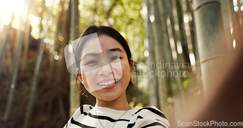 Image of Japanese woman, portrait and selfie in forest with smile, pride and bamboo in bush for post on web blog. Girl, person and happy influencer on adventure, trekking or hiking by trees for social media