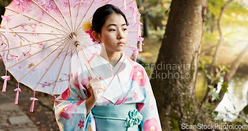 Image of Umbrella, traditional and Japanese woman in park for wellness, fresh air and thinking outdoors. Travel, culture and person in indigenous clothes, style and kimono for zen, peace and calm in nature