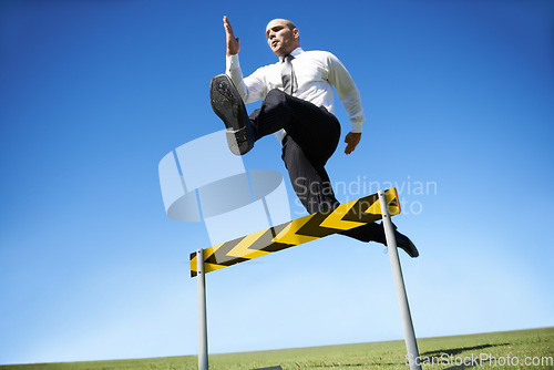 Image of Businessman, hurdle and jumping for career obstacle or competition or employee challenge, growth or achievement. Male person, leap and work professional goals for overcome, job development or mockup