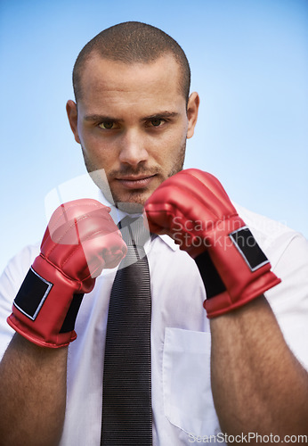 Image of Business man, portrait and boxing gloves for power or warrior, self defence and fitness in studio. Male person, strong and equipment for fight or corporate challenge, exercise and sky background