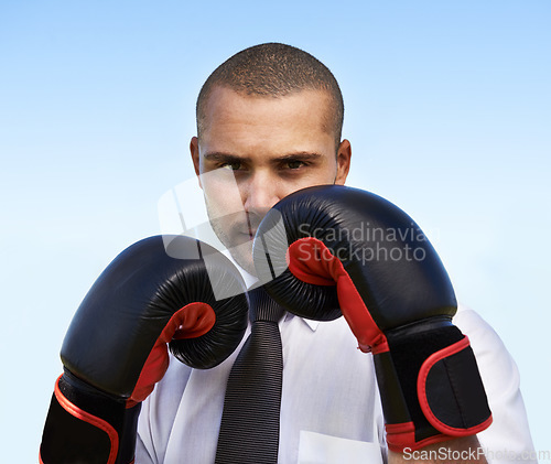 Image of Business man, portrait and boxing gloves for attack or warrior, self defence and fitness for power. Male person, strong and equipment for fight or corporate challenge, exercise and sky background