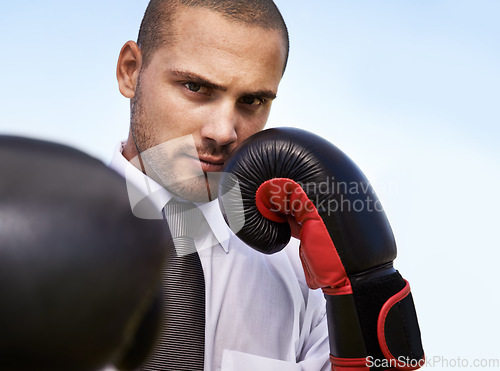 Image of Business man, portrait and boxing gloves for attack or warrior, self defence and fitness for power. Male person, strong and equipment for fight or corporate challenge, exercise and sky background