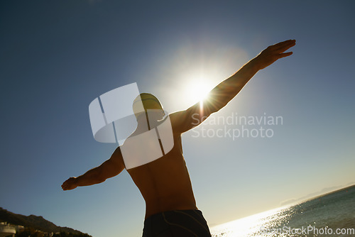 Image of Beach, sky and sports man for swimming exercise, nature workout or outdoor practice in water, sea or island. Freedom, sunset and back of athlete for challenge, fitness or cardio with Hawaii fresh air