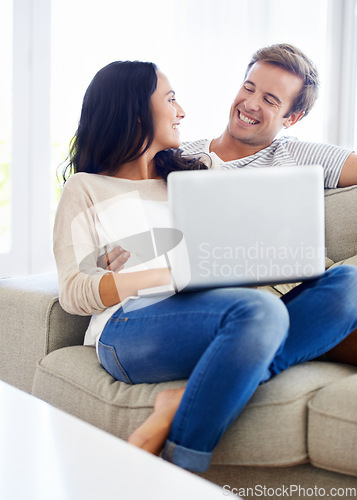 Image of Couple, laptop and relax together on sofa with love, living room and wellness in marriage for bonding. Woman, man and smile for relationship care on subscription, weekend and streaming video in home