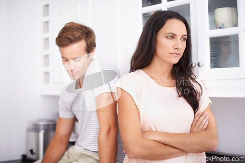 Image of Couple, fight and angry with conflict or drama in life, mistake or marriage fail with anxiety and stress at home. Frustrated people arguing in kitchen, cheating problem or crisis with risk of divorce