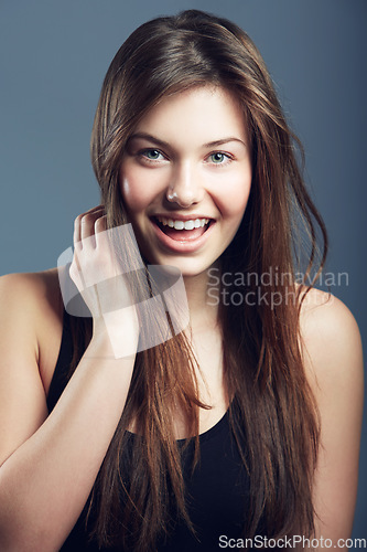 Image of Hair, smile and face of woman for beauty, cosmetics and shine, salon hairstyle and grooming on grey background. Portrait, haircare and wellness with glow, skin and Brazilian treatment in studio