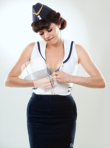 Image of Flight attendant, button shirt and a young woman in studio isolated on white background. Air hostess, pin up girl and stewardess, retro fashion model or vintage sailor in clothes to travel on journey