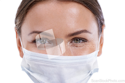 Image of Portrait, healthcare and woman doctor with face mask in studio for safety from illness or bacteria on white background. Medical, smile or eyes of nurse at hospital with cover for clinic compliance