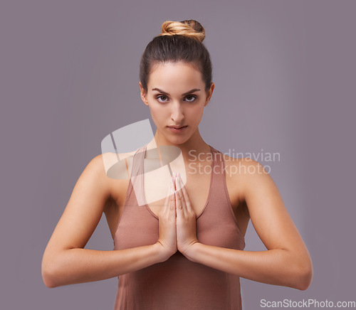 Image of Prayer, portrait or woman in meditation in studio for wellness, peace or calm on grey background. Face, relax or zen female model in yoga pose for chakra energy, mental health or holistic breathing