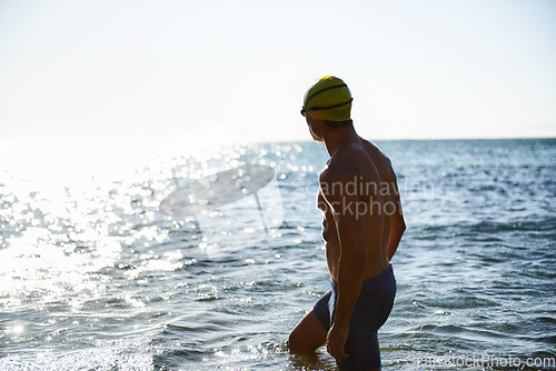 Image of Beach, ocean water and sports man for swimming exercise, workout or training in sea, nature and looking at horizon. Physical activity, Peru and back of athlete for cardio, fitness or morning practice
