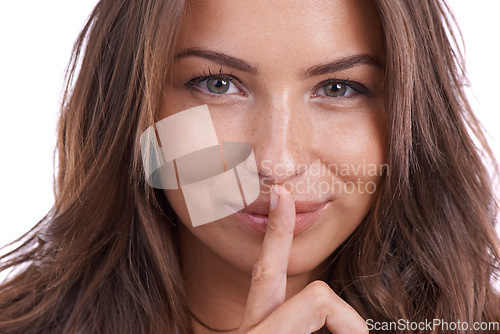 Image of Secret, portrait and woman with finger on lips in studio for quiet gesture, hush or whisper expression. Face, smile and female model with emoji for gossip, mouth or noise, confidential or drama