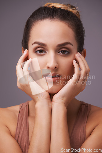 Image of Portrait, skincare and wellness with natural woman in studio on gray background for dermatology. Beauty, aesthetic and cosmetics with hands of young person on face or skin for antiaging treatment