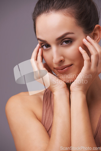 Image of Portrait, beauty and aesthetic with natural woman in studio on gray background for wellness or dermatology. Skincare, makeup or cosmetics with hands of young person on face for antiaging treatment