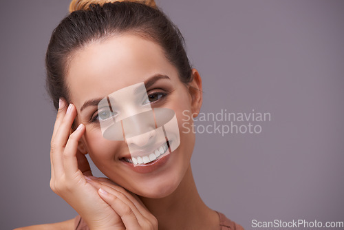 Image of Portrait, smile and beauty with woman on space in studio for skincare, wellness or natural cosmetics. Face, aesthetic and mockup with happy young person on gray background for natural dermatology