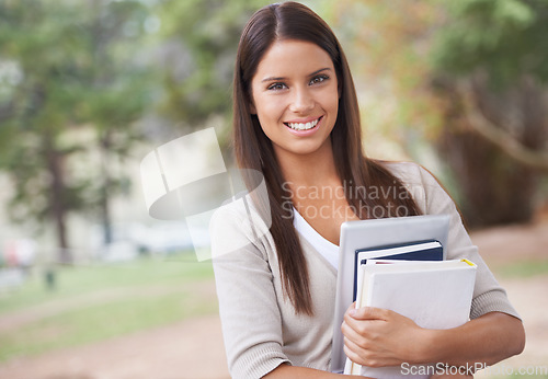 Image of Student, portrait and books with smile in outdoor nature, technology and education in learning for studying. University, young woman and face for phd research, park and commitment for scholarship