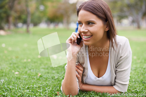 Image of Woman, phone call and relax on grass talking for communication, good news or gossip. Female person, smile and digital device in forest for holiday rest or laughing conversation, vacation or nature