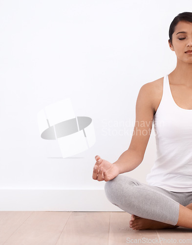 Image of Woman, meditation and spiritual in a home with mockup space and yoga for balance and mindfulness. Morning, wellness and zen in house on floor to relax for calm breathing and peace in lotus position