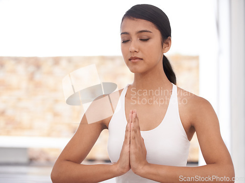 Image of Woman, prayer and meditation for yoga and mindfulness at home, fitness and health with healing and aura balance. Peace, calm and zen with young yogi, meditate for self care and wellness with workout