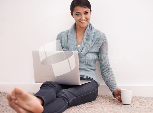 Image of Portrait, home and woman with a laptop, happy and coffee in a living room, digital app and remote work. Face, person on the floor or girl in a lounge, tech and website with daily blog and connection