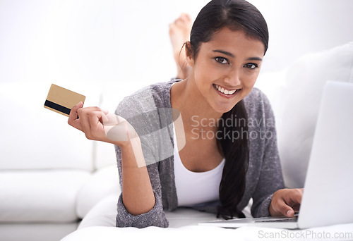 Image of Happy woman, portrait and credit card with laptop for online shopping, purchase or payment on sofa at home. Young female person smile with debit in relax on computer for ecommerce, fintech or banking