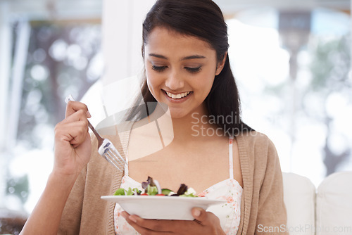 Image of Happy woman, bowl and eating salad for diet, healthy snack or natural nutrition on sofa in living room at home. Female person, vegan or nutritionist smile with mix vegetables for weight loss at house