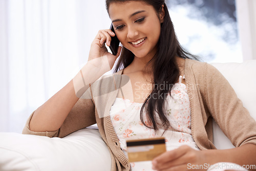 Image of Happy woman, phone call and credit card for online shopping, payment or banking on sofa at home. Female person talking on mobile smartphone with smile for ecommerce, debit or conversation on account