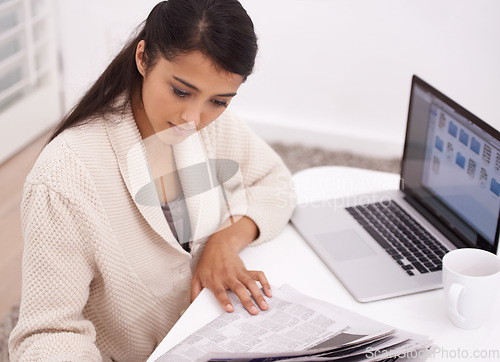 Image of Woman, morning newspaper and reading in house by laptop for remote work, economy or check stock market. Person, trader and newsletter for financial stats, information or thinking by computer in home