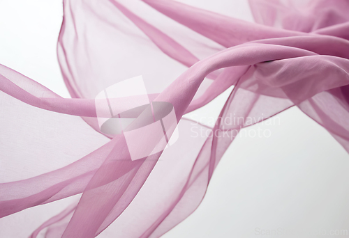 Image of Flying pink transparent fabric wave on white background