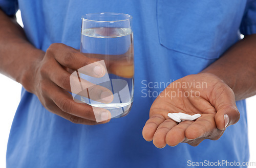 Image of Hands, pills and water for medication, virus and disease with drugs, medicine or vitamins. Nurse, pharmaceutical and healthcare for treatment, medical and tablets for closeup or prescription