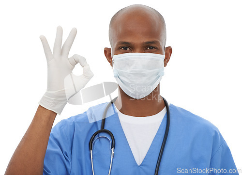 Image of Face mask, perfect sign and portrait of doctor in a studio with glove and stethoscope for consultation. Virus, protection and African male healthcare worker with ok hand gesture by white background.