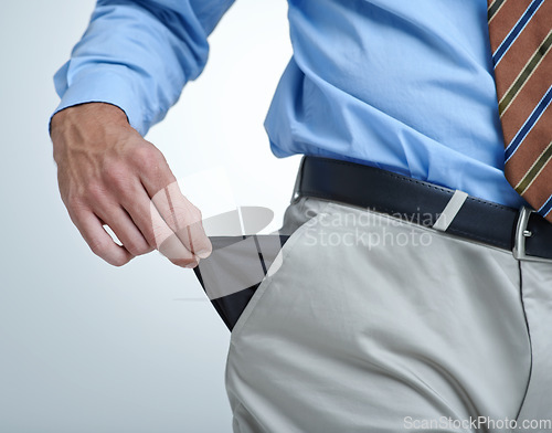 Image of Businessperson, empty pocket and poverty in studio, unemployment and bankruptcy by white background. Closeup, no money and financial trouble or bad investment, stock market crash and poor or broke