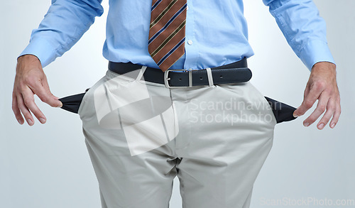 Image of Businessperson, empty pocket and poor in studio, unemployment and bankruptcy by white background. Closeup, no money and financial trouble or bad investment, stock market crash and debt or broke