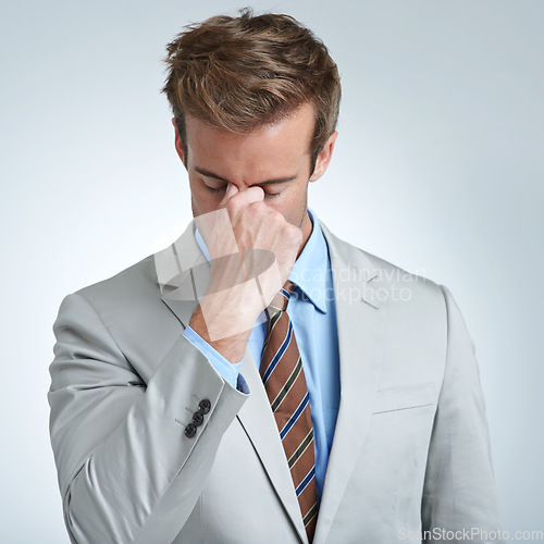 Image of Businessman, headache and stress in studio for job, mental health and bankrupt or debt. Male person, migraine and frustrated by white background, deadline and depression or mistake and tension