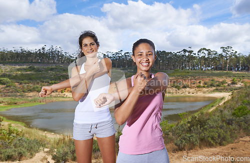 Image of Young women, stretching or portrait in forest to exercise, outdoor or trees by lake in nature. Diversity, people and face for happy to workout, blue sky and wellness with body training in countryside