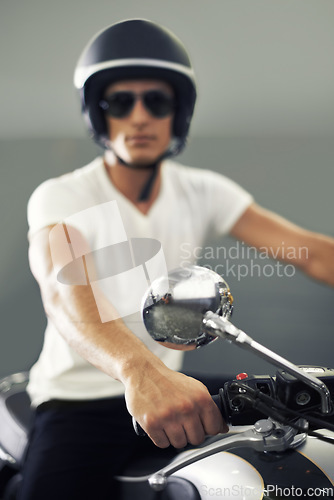 Image of Portrait, man and motorcycle with handlebar, cool and travel with hobby, riding and safety with fun. Face, person and biker with a helmet, stylish or sunglasses with protection, trendy outfit or road