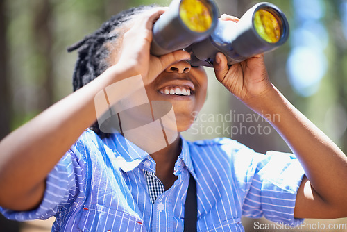 Image of Binocular, search and boy child in a forest for hiking, sightseeing or discovery. Lens, equipment and happy African kid in nature for adventure, learning or seeing, explore or watching while camping