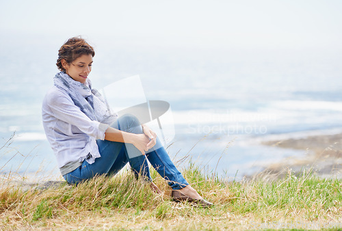 Image of Woman, thinking and relax in nature at beach with happiness, gratitude and peace on holiday or vacation. Ocean, mock up and person on hill at the sea with ideas for future, travel and environment