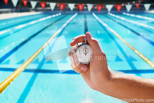 Image of Hand, stopwatch and swimming pool for sport, training and workout with preparation for competition. Person, coach or mentor with clock, timer or watch for speed, progress and tracking lap for race