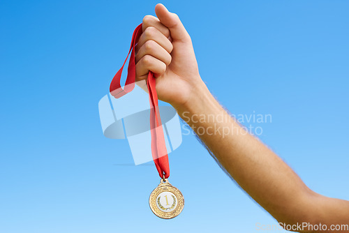 Image of Gold medal, sky and hands of sports person winning award, competition victory or game in outdoor contest. Marathon champion, triathlon winner or closeup athlete with prize, success and achievement