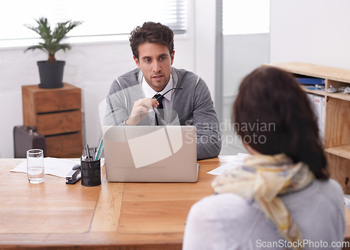 Image of Coworkers, laptop and office with interview, discussion and technology in workplace. Man, woman and businesspeople with manager, hiring or recruitment with conversation and professional agency