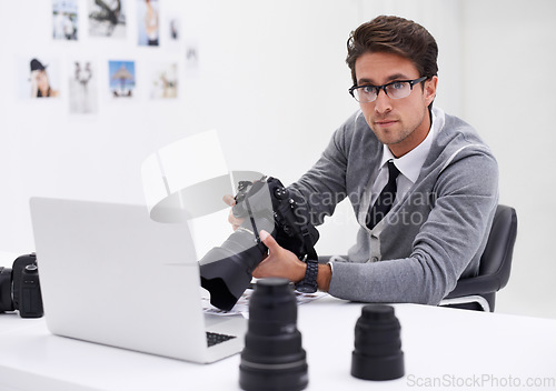 Image of Man, photographer and portrait with laptop, camera and lens for work, shoot and editing photographs. Professional, office and technology with creativity, internet and equipment for videography